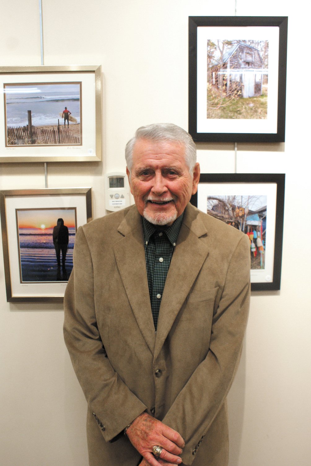 YEARS OF PHOTOS: Ed Rondeau, an Edgewood resident and retired Cranston teacher, stands by some of the photographs he’s taken over the years.